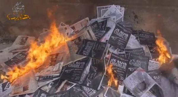 Picture of the burning of January 2015 issues of Souriatna, Enab Baladi, Sadaa Al-Shaam, and Tamaddon, by the opposition intelligence services Division of Information and Ahrar Al-Sham, due to their solidarity with the French newspaper Charlie Hebdo.
